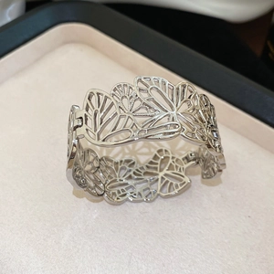 Macro shot of silver hollow butterfly cuff bracelet with intricate wing texture in box