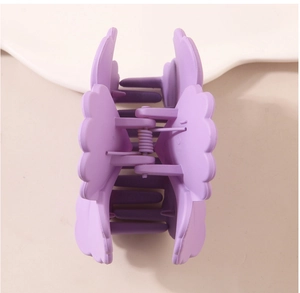 Detailed top view of purple matte flower petal hair claw clip with internal metal spring