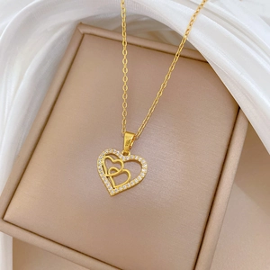 Gold double interlocking heart necklace with crystals in beige jewelry box