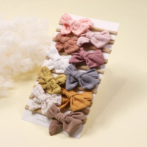 Detail of 10-piece set of soft nylon baby headbands with embroidered cotton bows