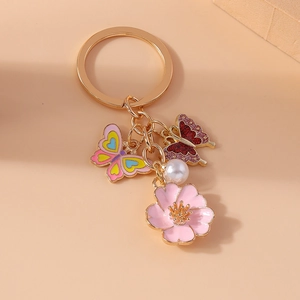Pastel cherry blossom and butterfly keychain with gold plating and white pearl charm