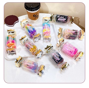 Colorful elastic hair ties packed in a candy-shaped box with golden crown details