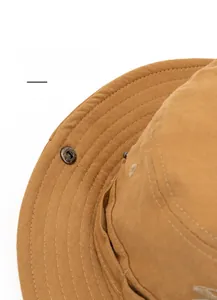 Detail of cotton sun hat with foldable brim and metal snap buttons for styling