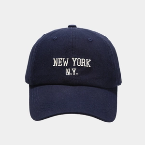Detail of navy blue twill cotton baseball cap with white New York embroidery
