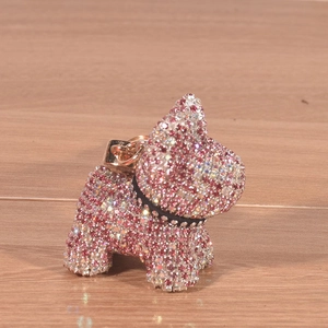 French Bulldog keychain with pink and silver rhinestones on a wooden background