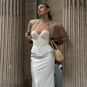 Lace corset and satin skirt styled with oversized khaki blazer in a street fashion look
