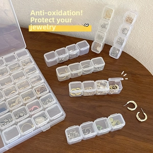 Close-up of transparent jewelry organizer boxes with multi-compartments for dust protection