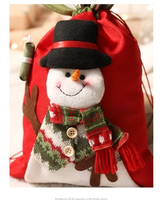 Close-up of a red Christmas drawstring gift bag featuring a 3D plush snowman with scarf