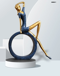 Artistic blue and gold yoga goddess resin statue in a seated pose with textured finish