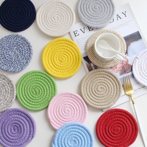 Set of colorful woven cotton rope coasters in various hues for heat-resistant table protection