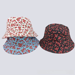 Detailed view of floral bucket hats in white, blue and black with small flower patterns