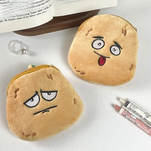 Detail of two funny potato plush coin purses with expressive faces and zip closures
