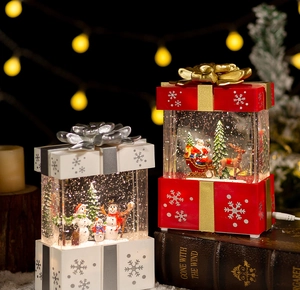Close-up of Christmas snowman water lantern with sparkling glitter and festive bokeh lights