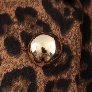 Leopard print velvet trench coat featuring golden metallic button detail on suede fabric