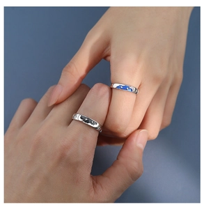 Detail of star and moon couple rings with navy blue enamel inlay and tiny sparkling diamonds