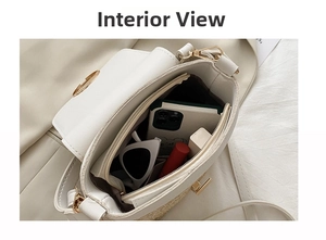 Interior view of straw and leather crossbody bag with items like phone and sunglasses