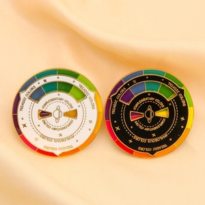 Macro shot of spinning enamel pins showing color theory concepts on soft beige silk background