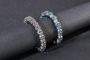 Detail of silver skull bracelet showing punk rock beads and intricate vintage metal texture