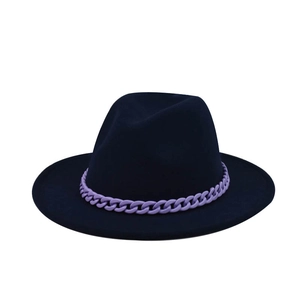 Detail of dark blue fedora hat featuring a matte purple chunky chain accent on the brim