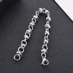 Detailed macro view of silver knotted link chain with lobster clasp on a dark background