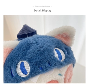 Detailed macro shot of the plush cat head backpack featuring blue faux fur and embroidery