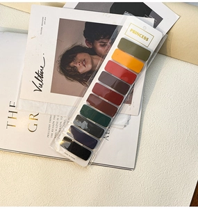 Detail view of 10 candy-colored matte hair clips packaged in a professional white card