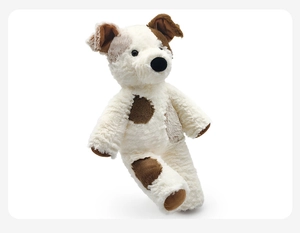 Close-up of soft plush puppy toy with white and brown patches and realistic fluffy texture