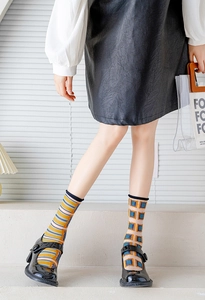 Detail of sheer glass silk socks featuring colorful stripes and blue geometric patterns