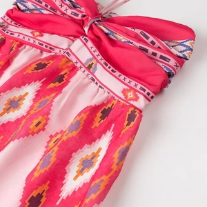 Close-up of bohemian ethnic print fabric featuring a tied bow detail and vibrant patterns