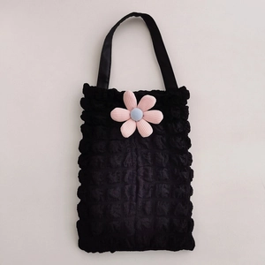 Detail of black popcorn texture car tissue holder with pink floral decoration