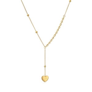 Detail of 18K gold Y-necklace featuring an asymmetrical chain and engraved heart pendant
