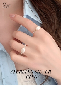 Detail of S925 sterling silver rings with natural pearls on model fingers