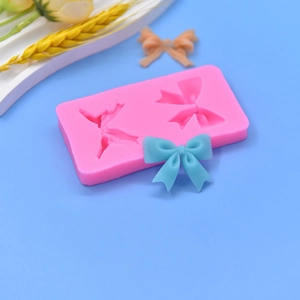 Pink silicone bow mold for DIY cake decorating and soap making with double cavities