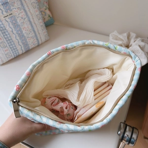Internal view of quilted blue floral checkered bag showing its storage capacity