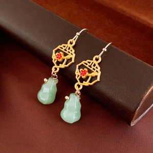 Detailed close-up of retro Chinese style earrings with jade gourd pendant and gold lattice