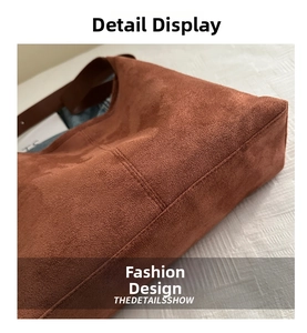 Detailed macro of the brown suede surface and fine stitching on a vintage tote bag