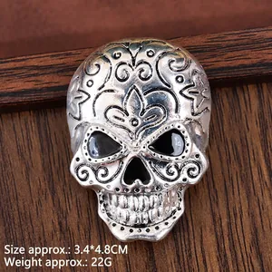Retro gothic skull brooch in oxidized silver finish with ornate floral engravings