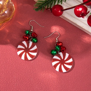 Detail of Christmas candy cane earrings with festive red and green metal bells and hooks