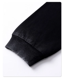 Macro shot of distressed ribbed cuffs on a 275g black washed cotton long sleeve T-shirt