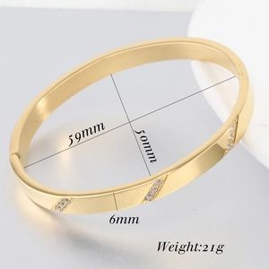 Macro detail of 6mm gold stainless steel bangle with slanted crystal inlay and dimensions