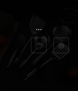 Detail of 7-piece stainless steel kitchen utensil set with mirror-polished finish