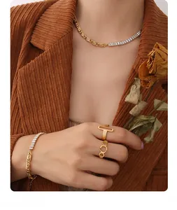 Detail of 18K gold-plated zircon chain necklace and bracelet on model with vintage style