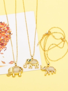 Close-up of gold plated elephant necklaces with zircon stones and O-chains in a warm setting