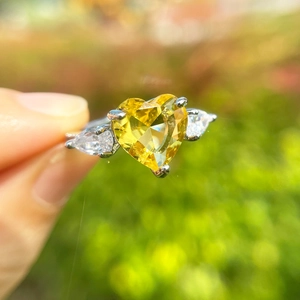 Three-stone heart-shaped yellow cubic zirconia ring with teardrop side stones in silver band