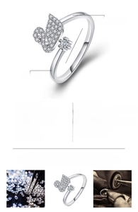 Detail view of silver-plated swan open ring with stones and product specification chart