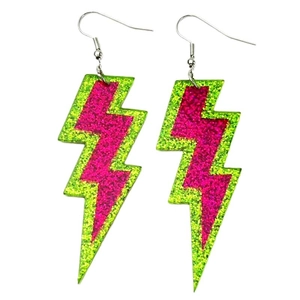 Detail shot of neon green and magenta lightning earrings with sparkling glitter finish