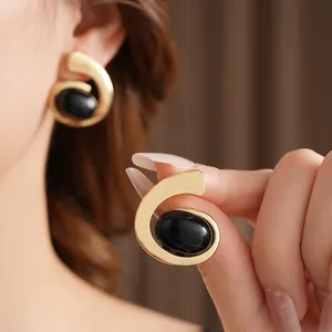 Minimalist geometric spiral earrings with gold frame and oval black gemstone