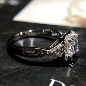 Vue latérale d'une bague de fiançailles halo avec diamant carré et anneau torsadé