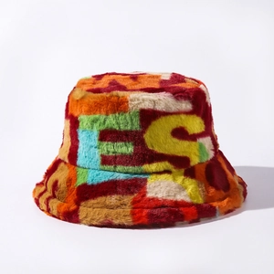 Close-up of colorful faux fur bucket hat featuring fluffy texture and letter design
