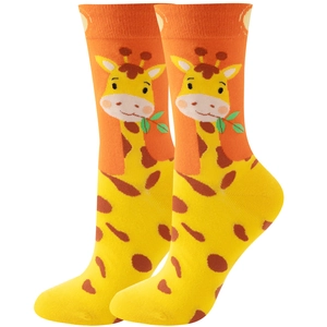 Close-up of funny orange and yellow mid-tube socks with cute cartoon giraffe patterns